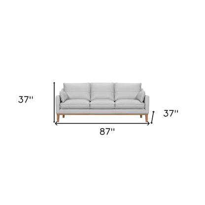 Gray Leather Sofa & Toss Pillows With Brown Legs